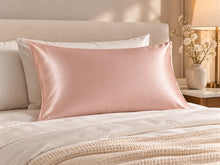 Smoozely silk pillowcase in a bedroom setting, colour soft blush